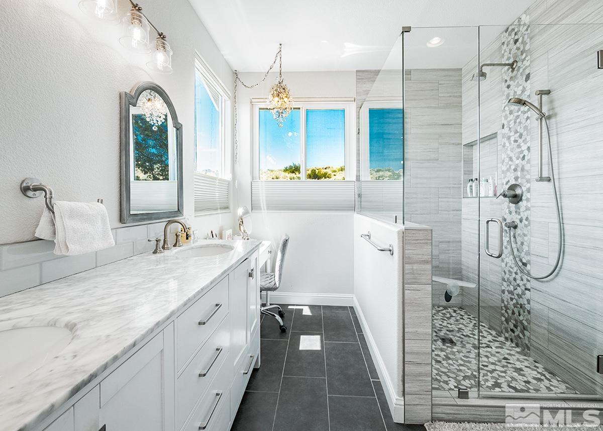 3095 Roxbury Drive Reno, NV 89523 - Photo 19 of 36 a spacious bathroom with a granite countertop sink mirror and shower