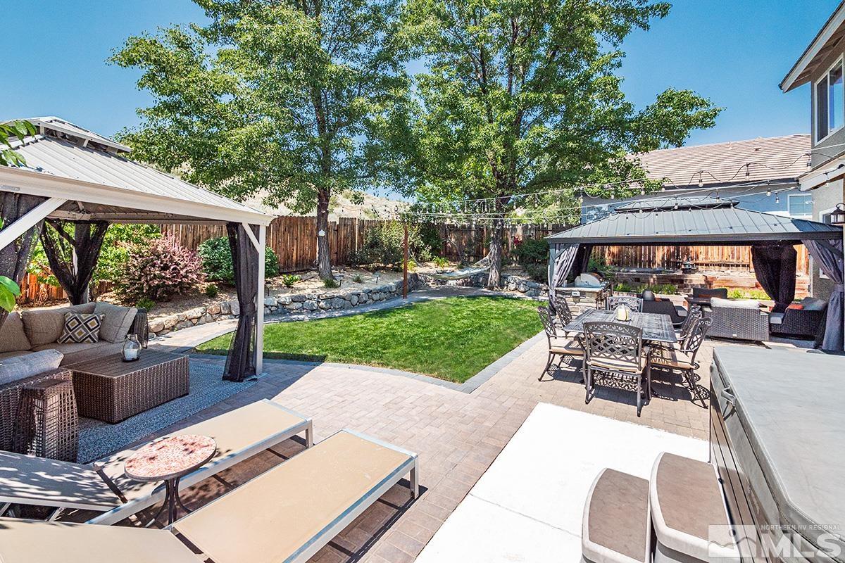 3095 Roxbury Drive Reno, NV 89523 - Photo 27 of 36 a view of a patio with couches table and chairs under an umbrella