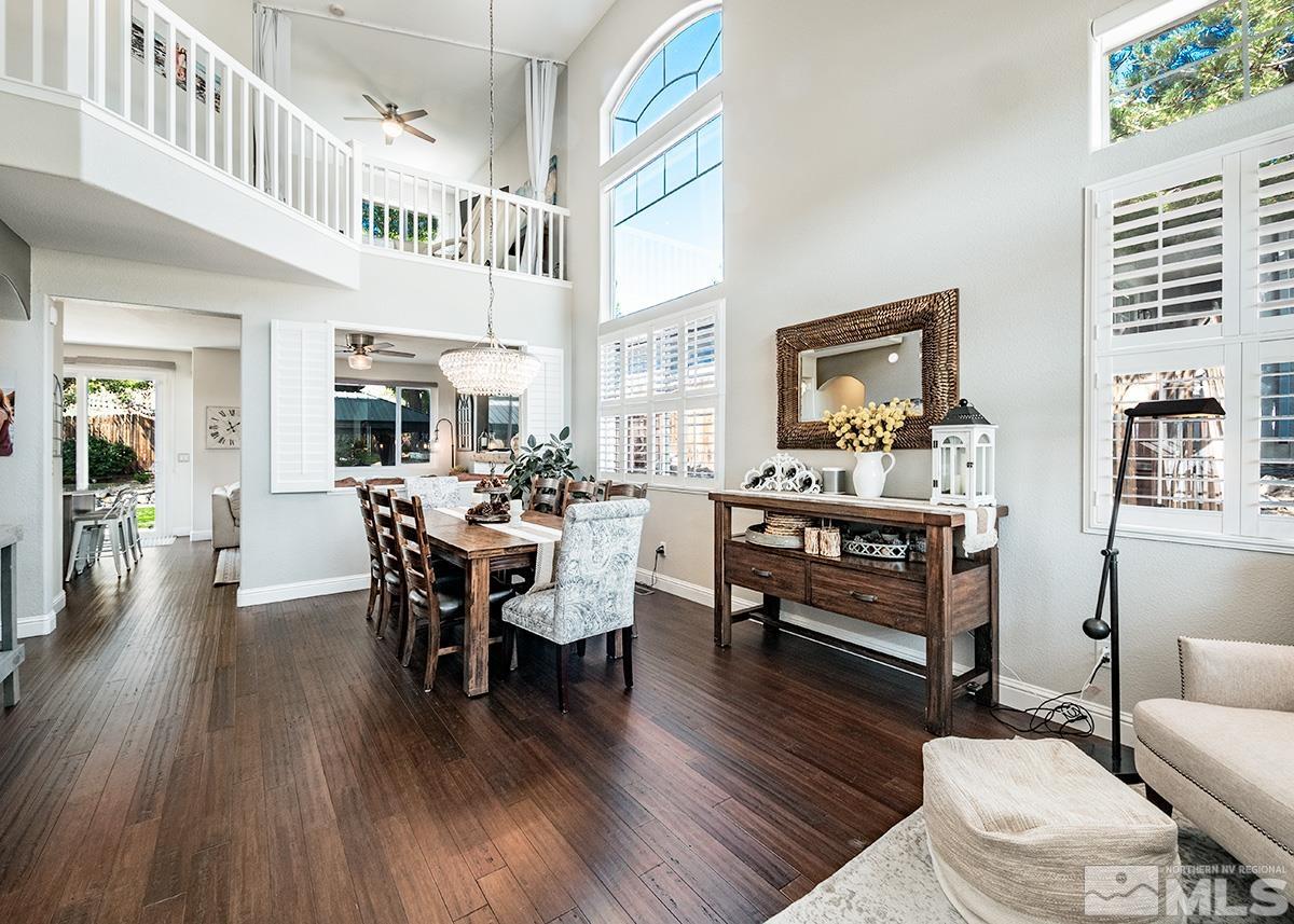 3095 Roxbury Drive Reno, NV 89523 - Photo 3 of 36 a dining room with wooden floor a chandelier a glass table and chairs