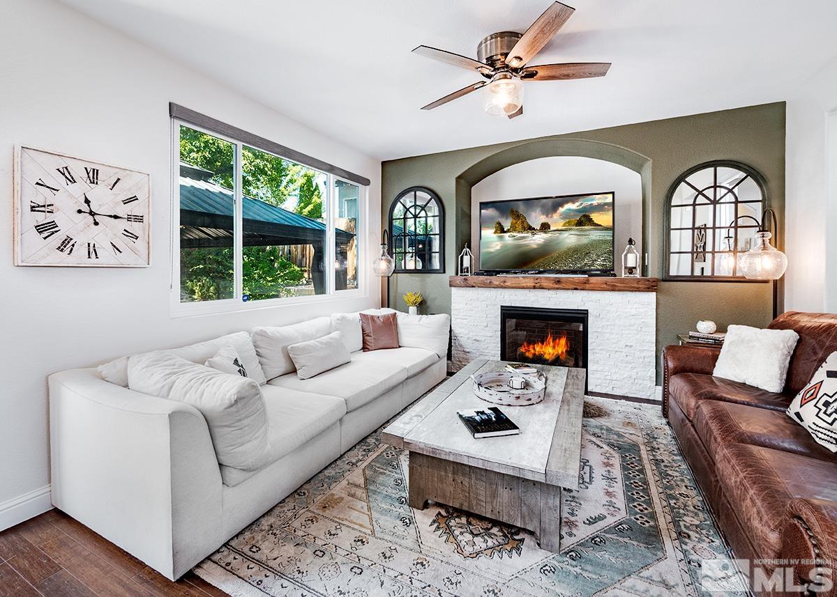 3095 Roxbury Drive Reno, NV 89523 - Photo 5 of 36 a living room with furniture a fireplace and a large window