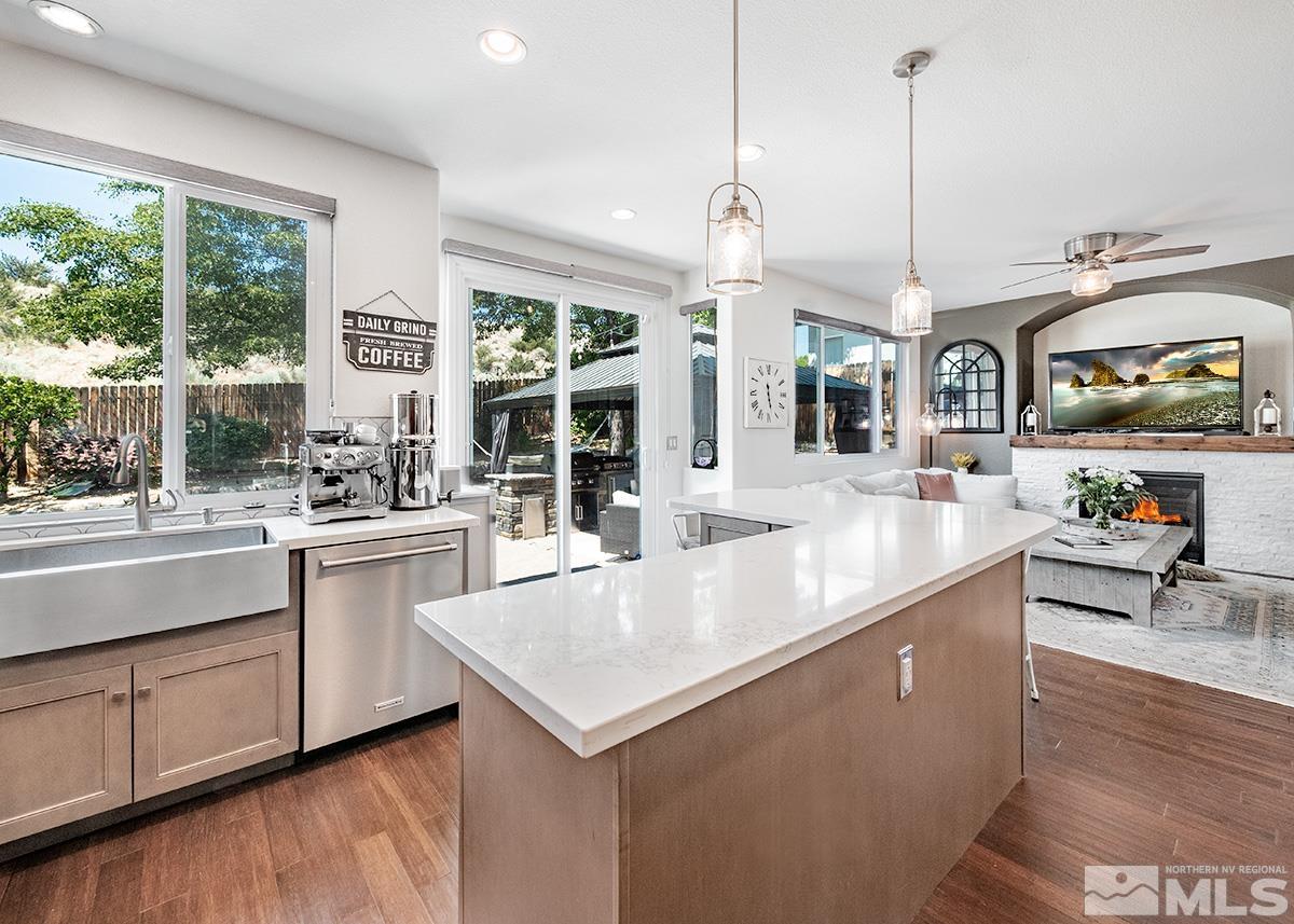 3095 Roxbury Drive Reno, NV 89523 - Photo 10 of 36 a large kitchen with kitchen island a large counter top space a sink stainless steel appliances and cabinets