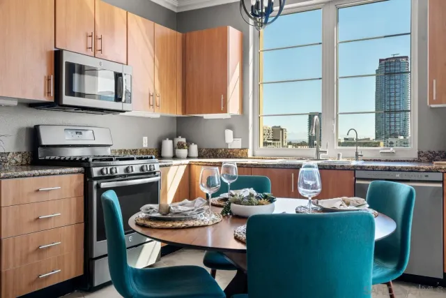 a dining room with furniture a window and kitchen view