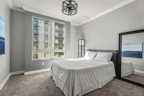 a bedroom with a bed and a mirror