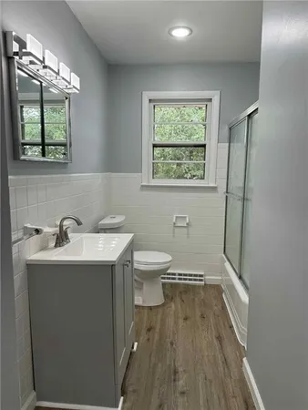 a bathroom with a sink toilet and window