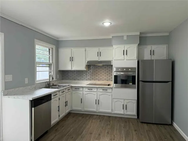 a kitchen with a white cabinets and white appliances