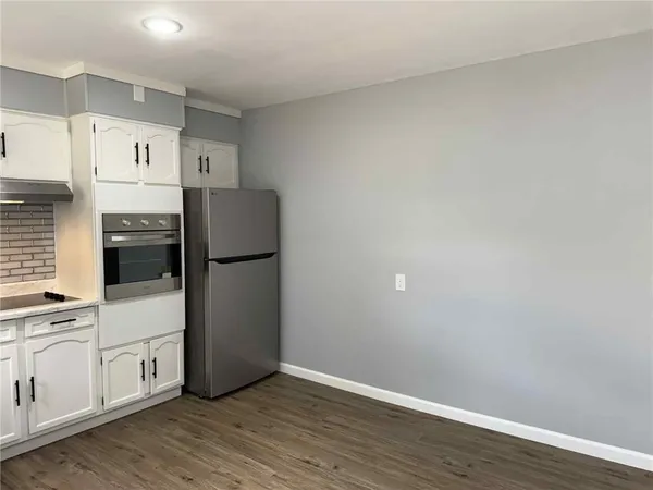 a kitchen with a refrigerator and a stove top oven