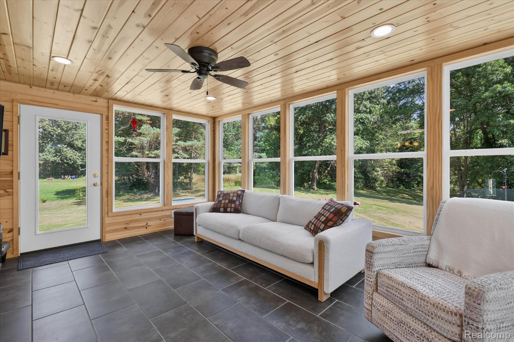 4037 Chilson Road Howell, MI 48843 - Photo 16 of 69 Sunroom featuring a wood-paneled ceiling, recessed lighting, ceiling fan, expansive windows, and dark tile flooring