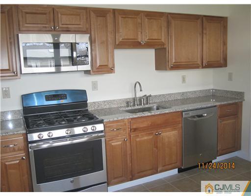 139 Winthrop Road Edison, NJ 08817 - Photo 6 of 17 a kitchen with stainless steel appliances granite countertop a stove a sink and a microwave