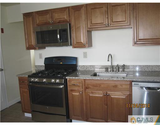 139 Winthrop Road Edison, NJ 08817 - Photo 7 of 17 a kitchen with granite countertop a stove sink and cabinets