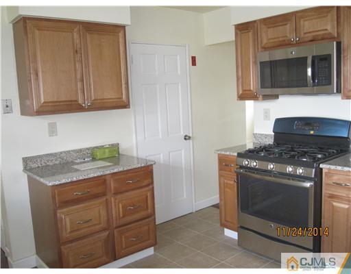 139 Winthrop Road Edison, NJ 08817 - Photo 8 of 17 a kitchen with stainless steel appliances granite countertop a stove and a microwave