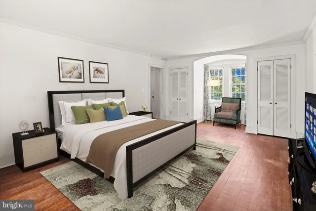 a living room with a bed furniture and a window