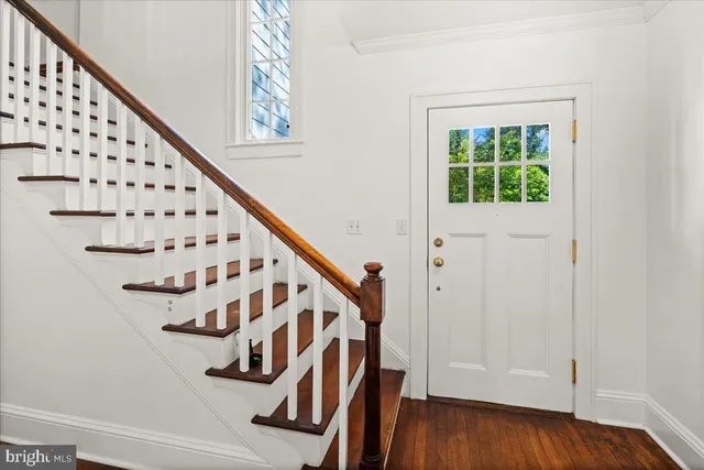 a view of an entryway with wooden floor