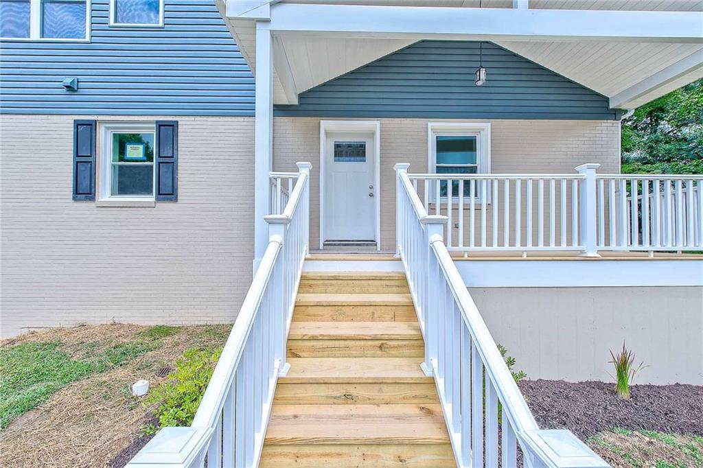 Welcome guests with this wide, beautiful entrance with vaulted porch roofline and outdoor chandelier. Surrounded by picture-perfect white railings adding loads of character to the front faade and requiring no maintenance.