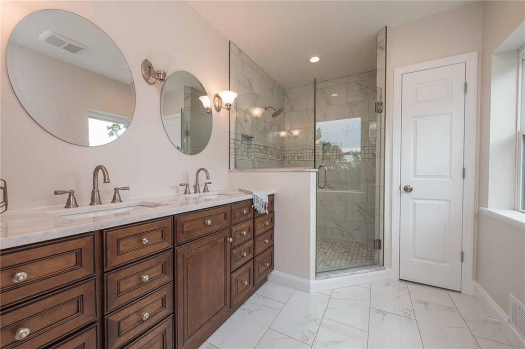 226 McCoy Place Road Sewickley, PA 15143 - Photo 13 of 25 Main level master bath is a welcome spa retreat! Marble-topped double vanity with beautiful cabinetry provides luxury and plenty of storage space. Glass-enclosed extra large shower is lined with marble and beautiful tile work.