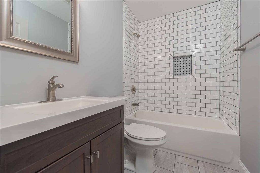226 McCoy Place Road Sewickley, PA 15143 - Photo 16 of 25 Sleek wood vanity and beautiful tile work make this spacious full bathroom perfect for family or guests.