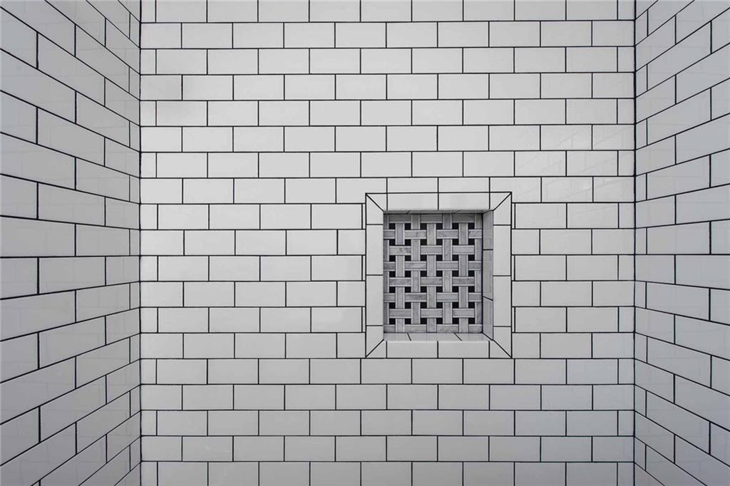 226 McCoy Place Road Sewickley, PA 15143 - Photo 17 of 25 Marble basketweave tile in niche provides a beautiful space for soap and shampoo.