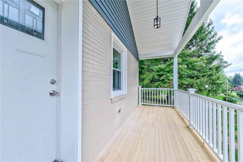 Imagine sitting with your morning coffee on this lovely front porch in this mature, quiet neighborhood. Overlooking the nicely landscaped large front yard.