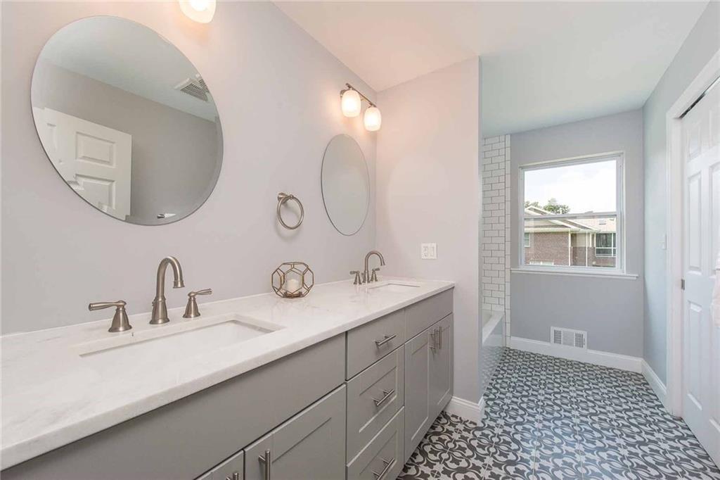 226 McCoy Place Road Sewickley, PA 15143 - Photo 21 of 25 The unique tile floor in this bathroom, along with the other tile work, gives it a opulent feel. Light gray vanity topped with marble counter and double sinks provides amazing storage space.