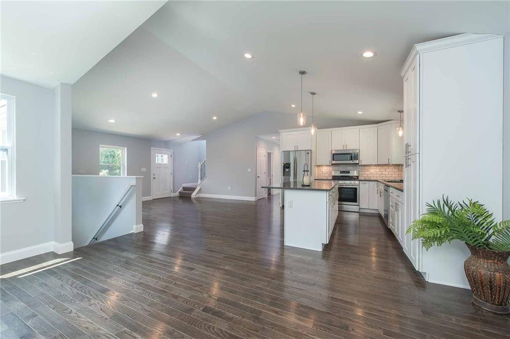 Wonderful open floorplan makes this the heart of the home. Gorgeous wood flooring throughout the main living space provides character and gives this home a special warmth. The light grey walls add an airy and light feel.