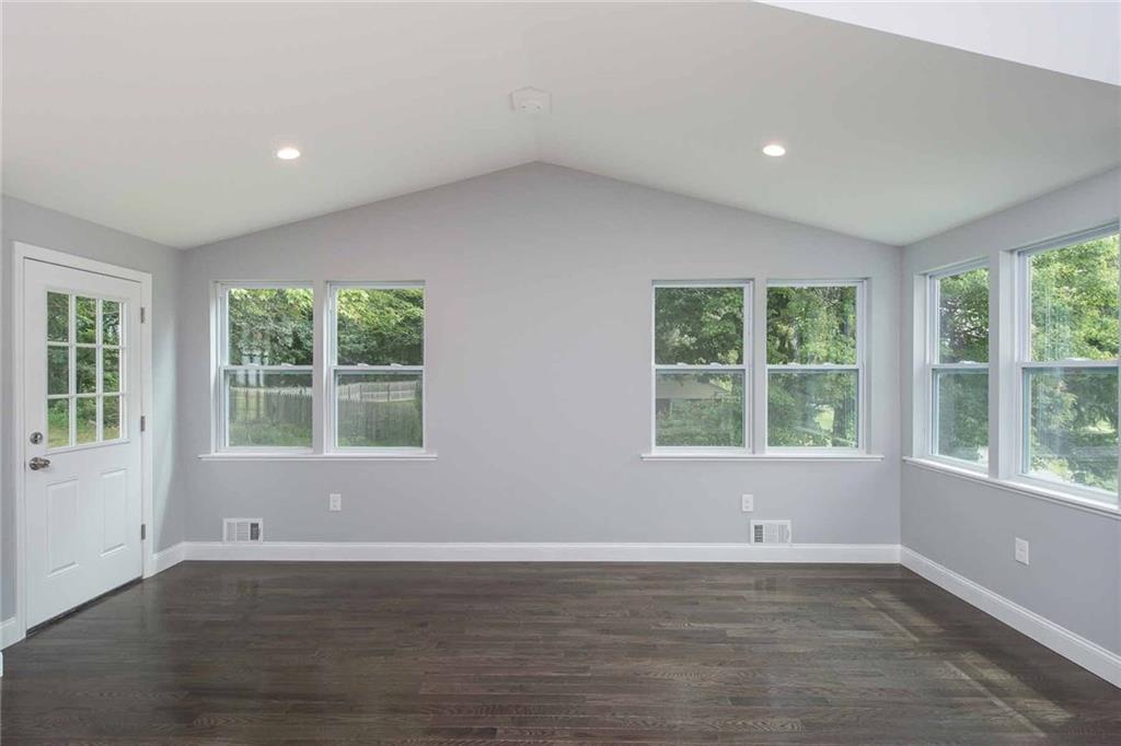 Fabulous views and loads of natural light.  Surrounded by windows, this large vaulted ceiling area off of the kitchen provides for a dining space that can handle the largest of dinner parties.
