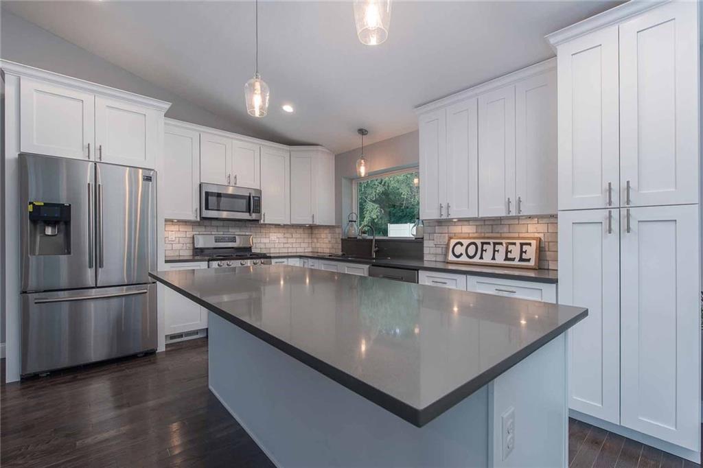 Large pantry with expansive shelving for plenty of food storage. Room for stools at the center island for breakfast on busy mornings or any time for family dinners. Kitchen is bright and open to the living area so the cook is able to socialize with guests while entertaining.