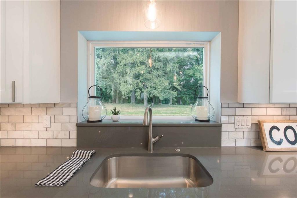 226 McCoy Place Road Sewickley, PA 15143 - Photo 9 of 25 What a view! While standing in kitchen, the beautiful flat back yard and woods are easily visible to see children playing or to just relax and watch the stunning nature scene. Light floods into kitchen from this amazing picture window above the oversized sink. A large quartz shelf above sink is a beautiful place to set plants.