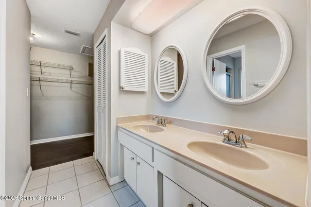 a bathroom with a double vanity sink and mirror