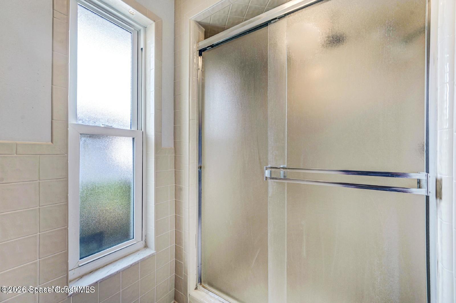 296 Sandy Run Melbourne, FL 32940 - Photo 13 of 23 a bathroom with a glass shower door