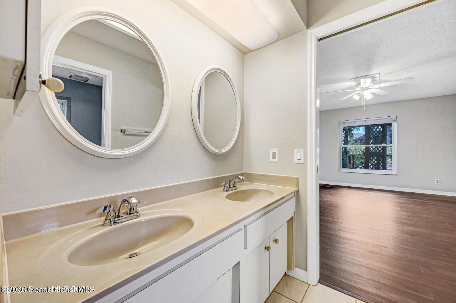 296 Sandy Run Melbourne, FL 32940 - Photo 15 of 23 a bathroom with 2 sink and a mirror