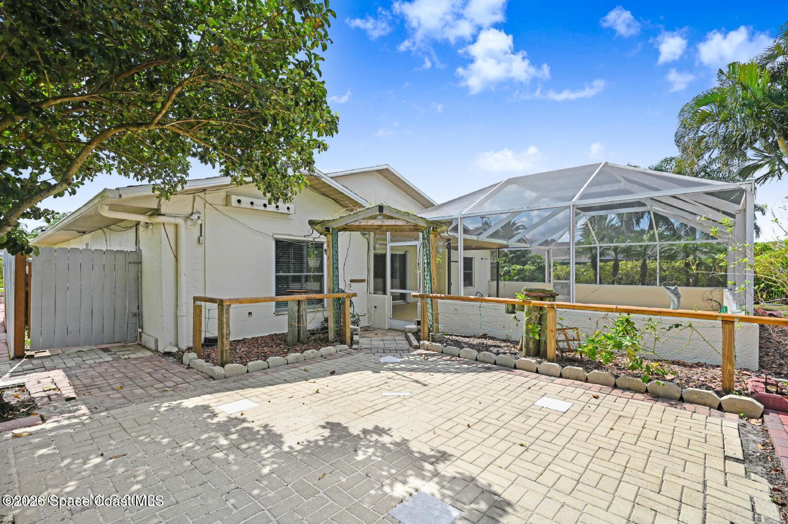 296 Sandy Run Melbourne, FL 32940 - Photo 22 of 23 a front view of a house with a yard and potted plants
