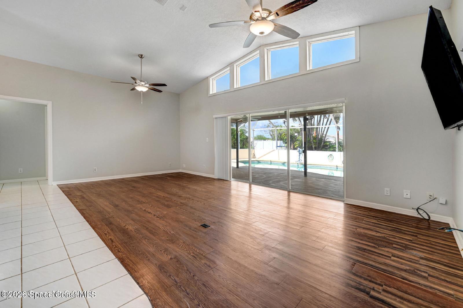 296 Sandy Run Melbourne, FL 32940 - Photo 4 of 23 wooden floor in an empty room with a window