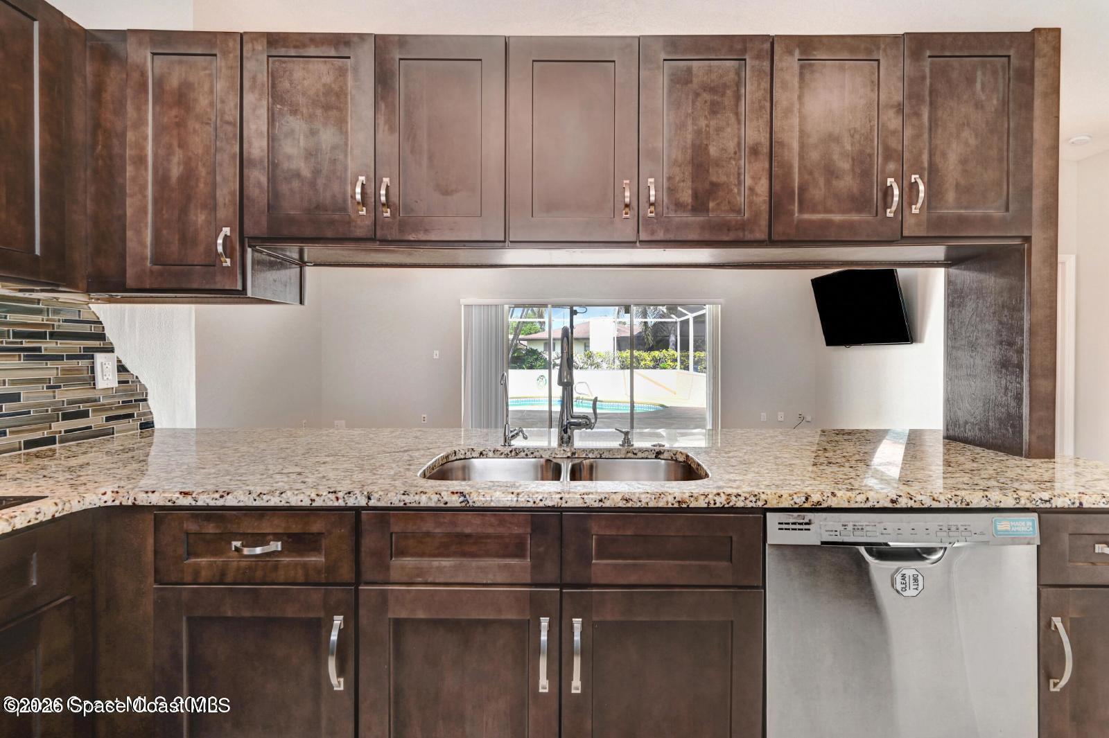 296 Sandy Run Melbourne, FL 32940 - Photo 8 of 23 a kitchen with granite countertop cabinets and window