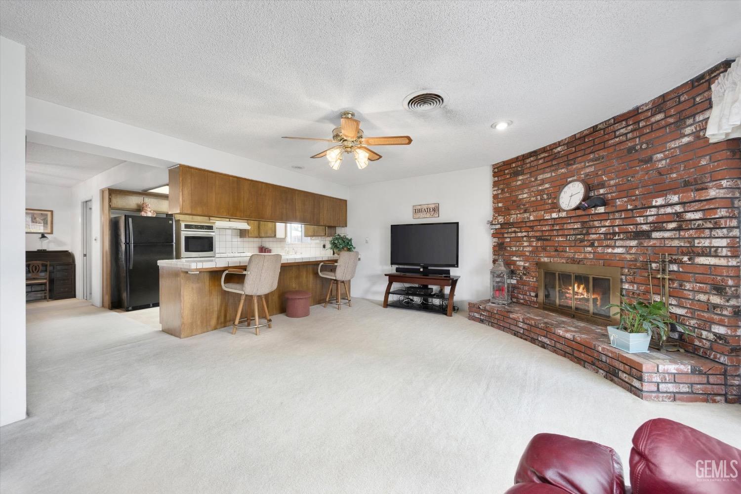 Undisclosed Address Bakersfield, CA 93311 - Photo 14 of 35 a living room with furniture a flat screen tv and kitchen view