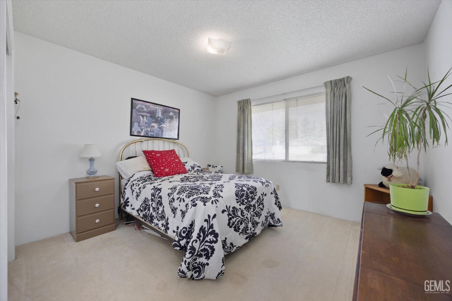 Undisclosed Address Bakersfield, CA 93311 - Photo 19 of 35 a bedroom with a bed and a painting on the wall