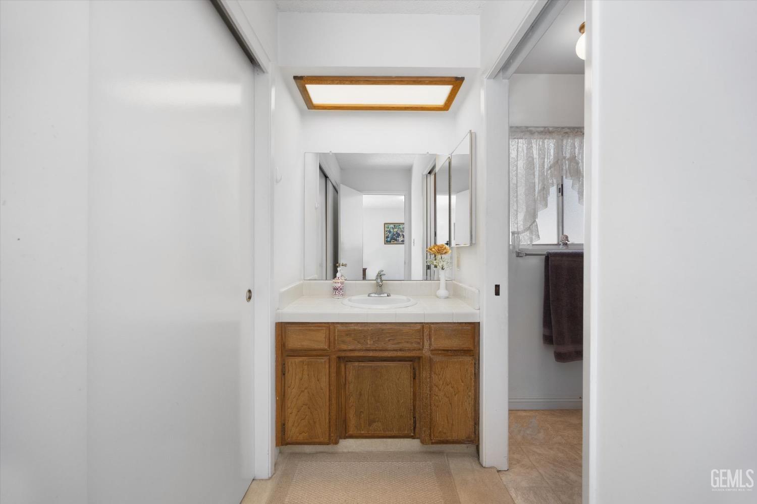 Undisclosed Address Bakersfield, CA 93311 - Photo 23 of 35 a bathroom with a sink and a mirror
