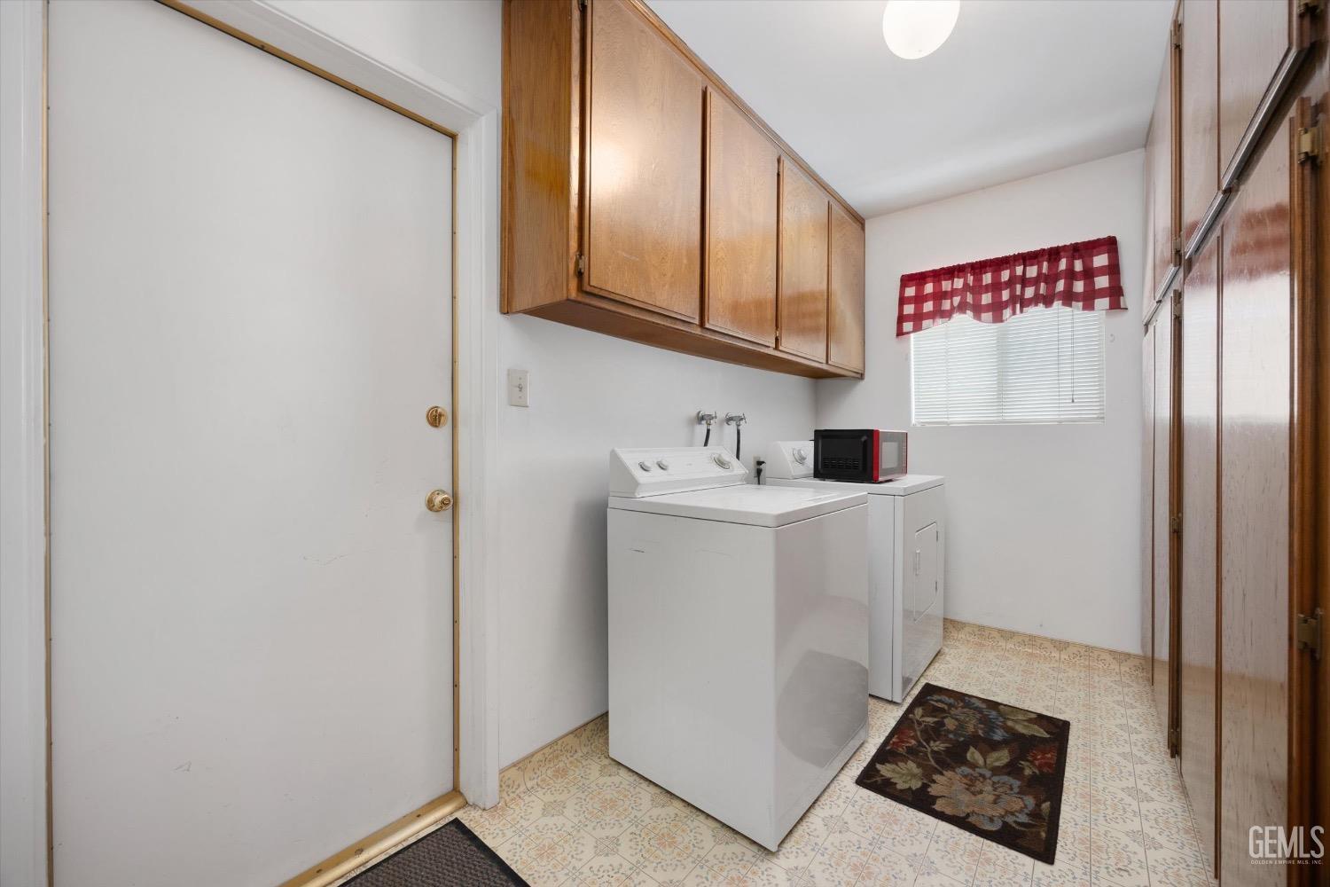 Undisclosed Address Bakersfield, CA 93311 - Photo 27 of 35 a utility room with cabinets washer and dryer