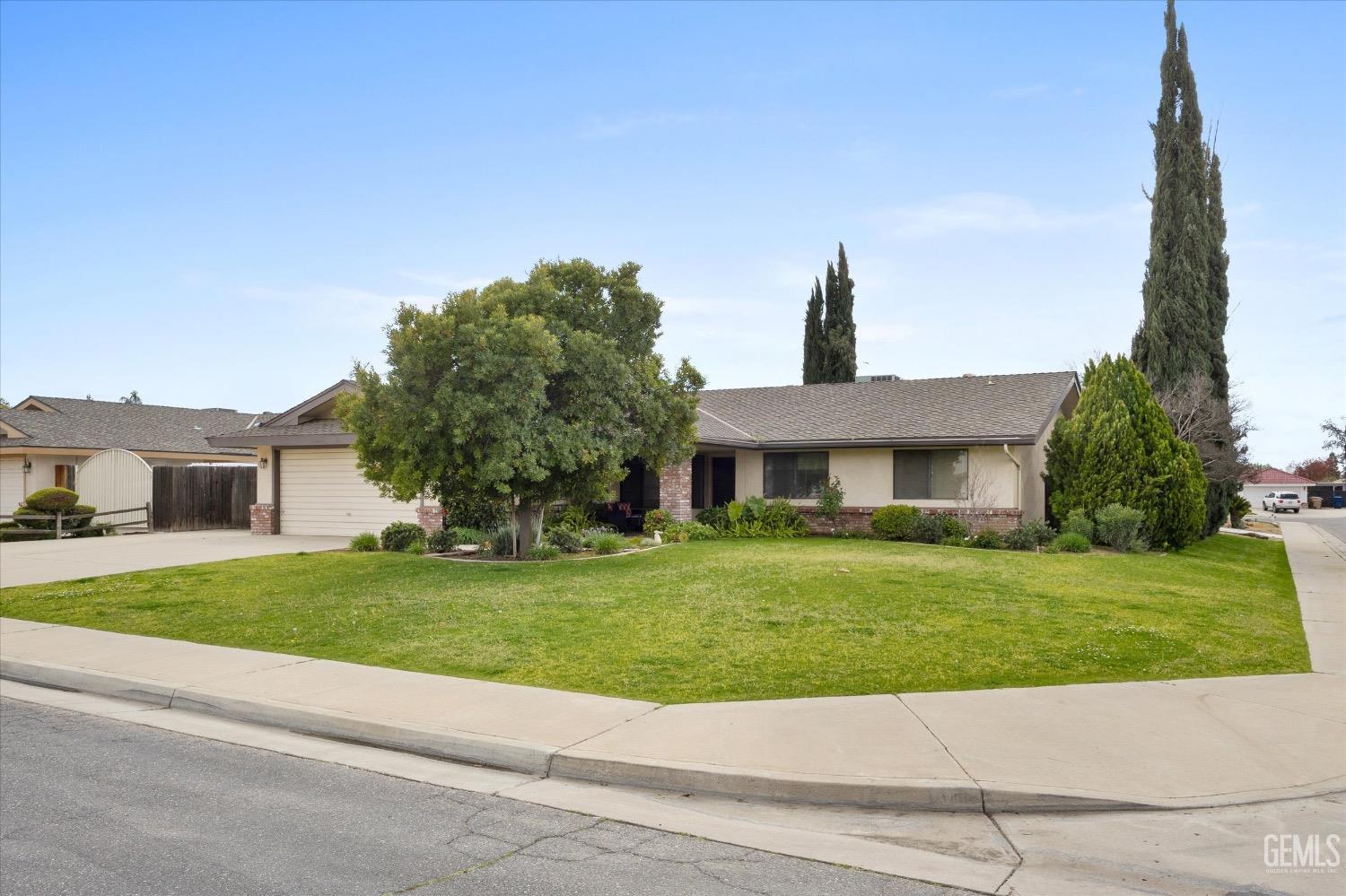 Undisclosed Address Bakersfield, CA 93311 - Photo 3 of 35 a front view of a house with a garden