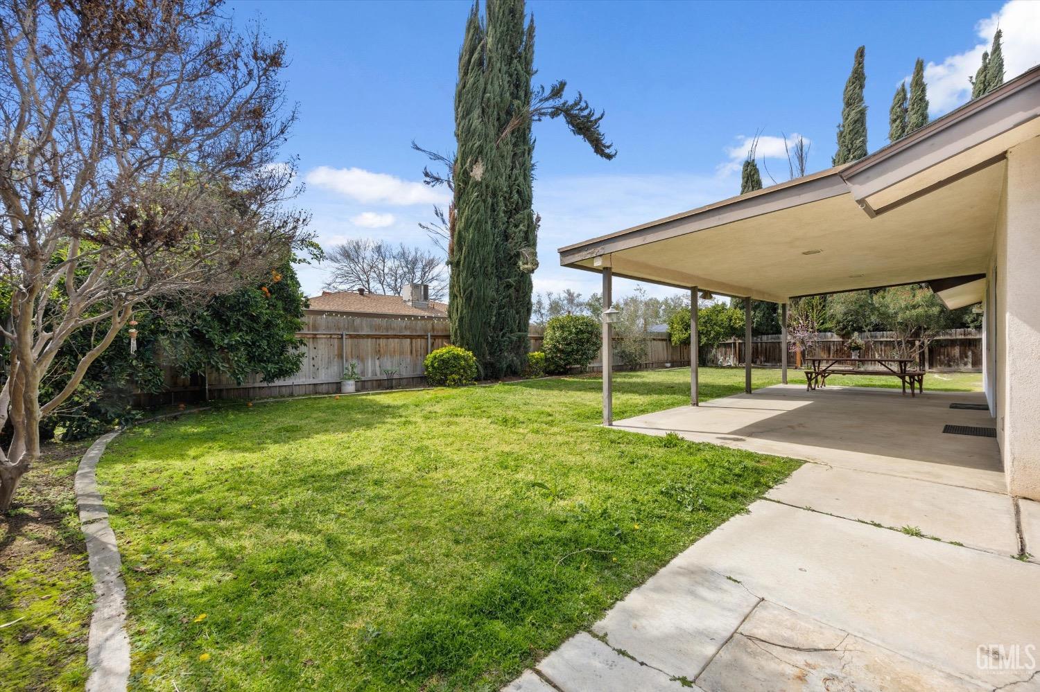 Undisclosed Address Bakersfield, CA 93311 - Photo 31 of 35 a view of a patio with a table and chairs under an umbrella