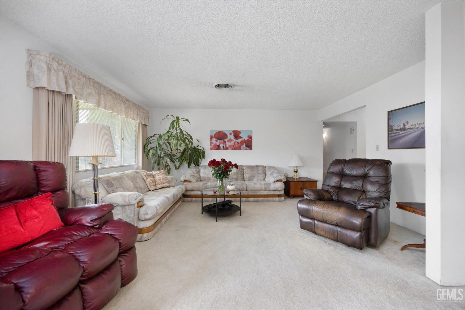 Undisclosed Address Bakersfield, CA 93311 - Photo 7 of 35 a living room with furniture and a couch