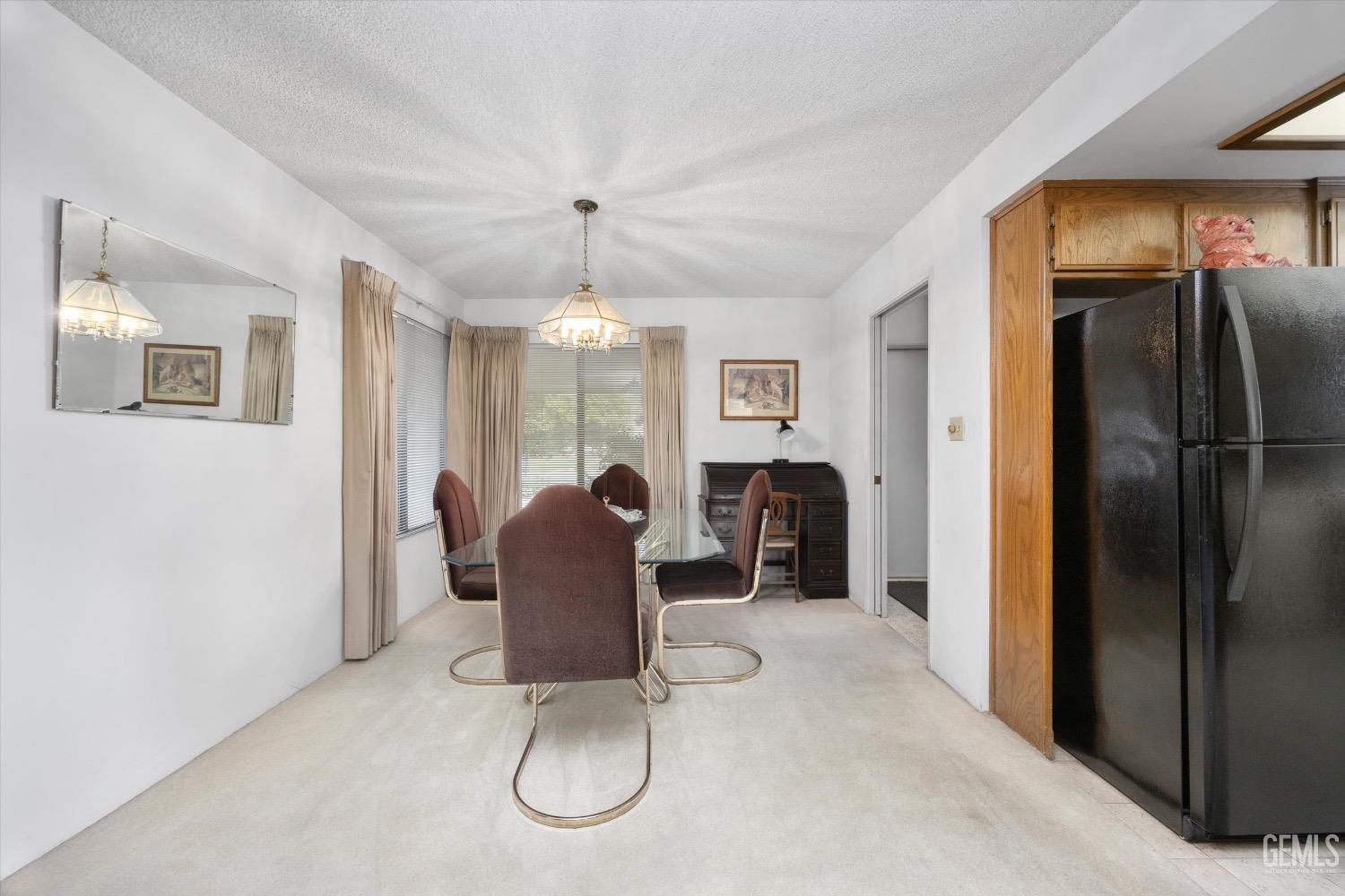Undisclosed Address Bakersfield, CA 93311 - Photo 9 of 35 a view of a dining room with furniture a chandelier and window