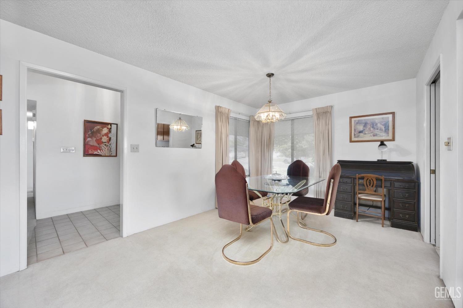Undisclosed Address Bakersfield, CA 93311 - Photo 10 of 35 a work room with furniture a flat screen tv and a fireplace