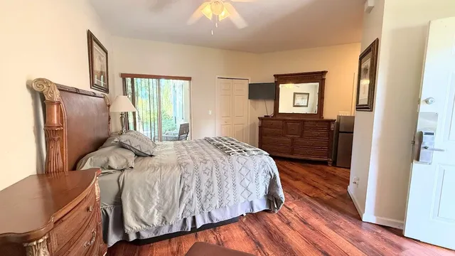 a bed sitting in a bedroom next to a window with dresser