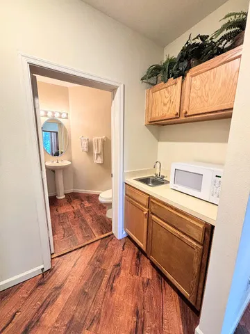 a room with wooden cabinets and a window