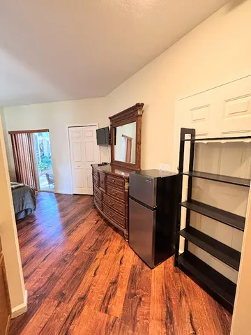 a living room with wooden floor and furniture