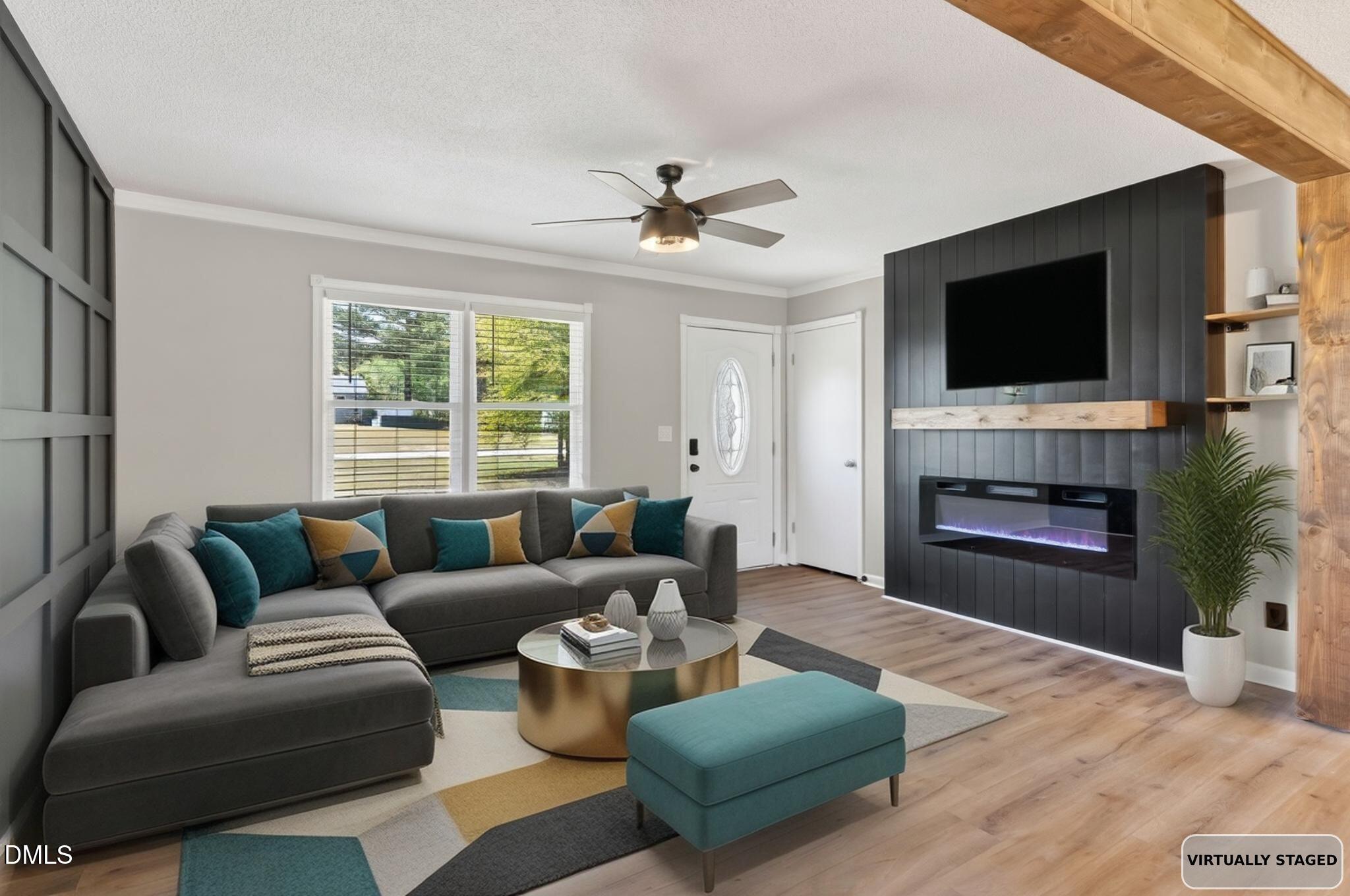 6086 Red Hill Church Road Coats, NC 27521 - Photo 5 of 44 a living room with furniture a flat screen tv and a fireplace