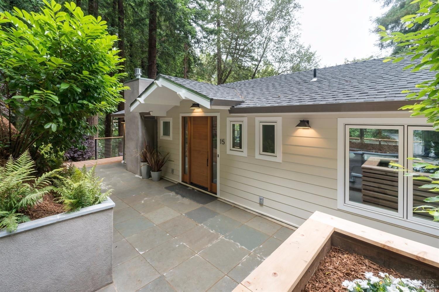 a front view of a house with a garden