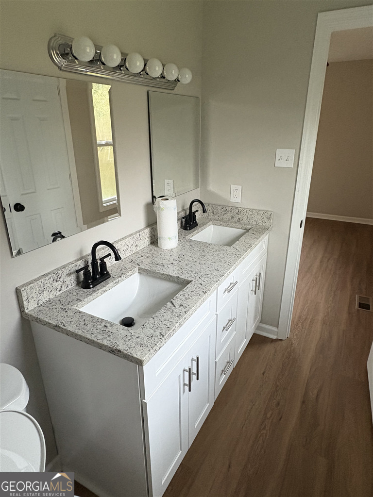 358 Misty Mills Road Lavonia, GA 30553 - Photo 5 of 7 a bathroom with a granite countertop double vanity and a mirror
