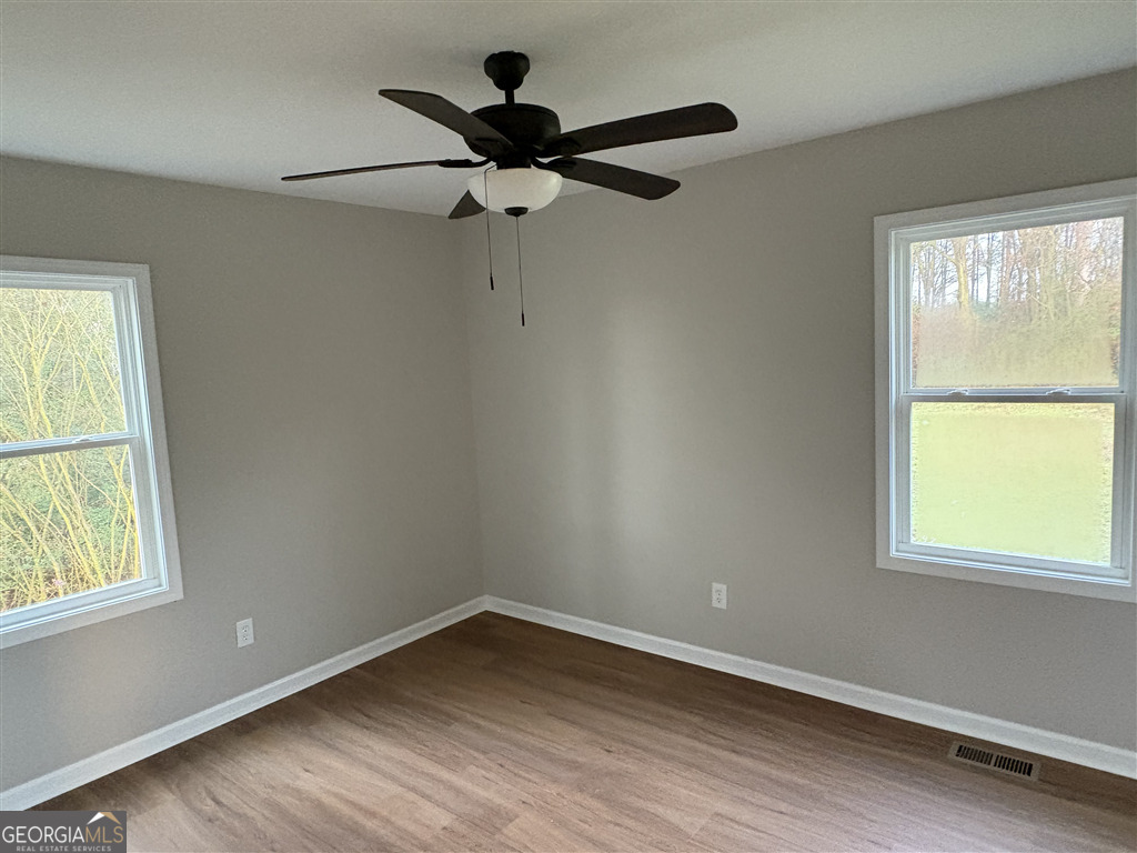 358 Misty Mills Road Lavonia, GA 30553 - Photo 6 of 7 a view of empty room with wooden floor and fan