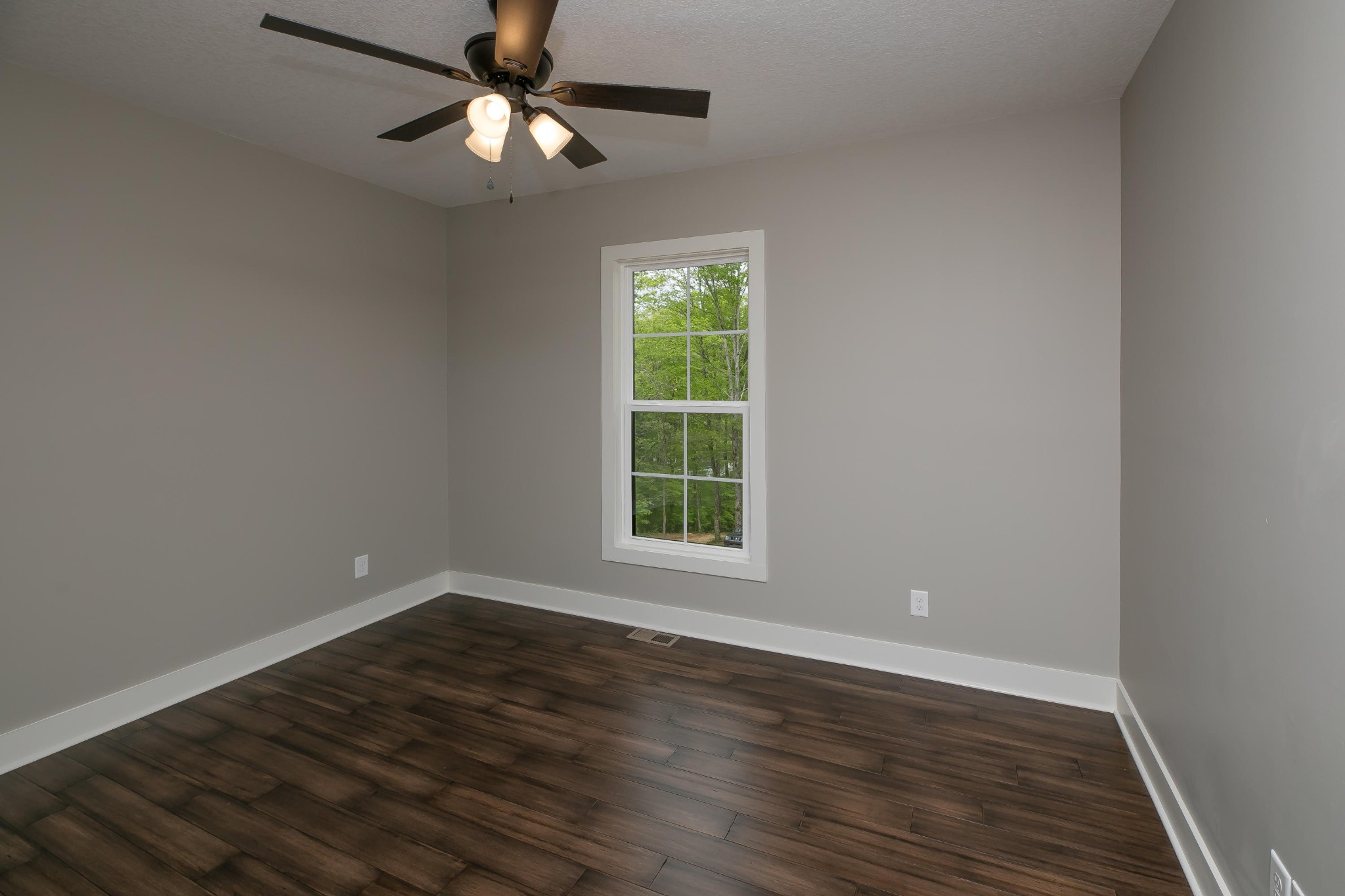 3423 West Wolf Valley Road Clinton, TN 37716 - Photo 23 of 34 a view of an empty room with wooden floor and a window