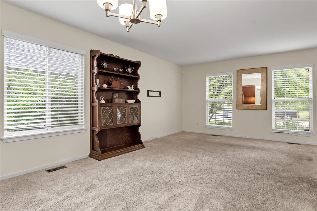 2591 Smithfield Lane Aurora, IL 60503 - Photo 12 of 31 a view of an empty room with a window and kitchen area